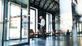 demo-attachment-30-Mature-businessman-with-smartphone-in-the-office.